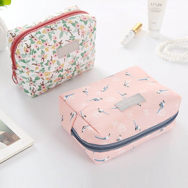 Travel Cosmetic Bag Portable Cosmetic Storage Bag by The Daily Drop with floral patterns and cube shape.