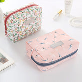 Travel Cosmetic Bag Portable Cosmetic Storage Bag by The Daily Drop with floral patterns and cube shape.