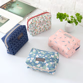 Travel Cosmetic Bag Portable Cosmetic Storage Bag by The Daily Drop in various floral and patterned designs.