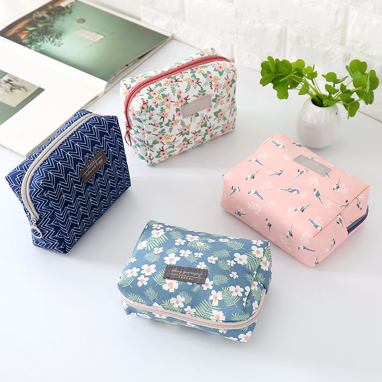 Travel Cosmetic Bag Portable Cosmetic Storage Bag by The Daily Drop in various floral and patterned designs.