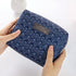 Travel Cosmetic Bag Portable Cosmetic Storage Bag featuring a navy blue zigzag pattern, The Daily Drop.
